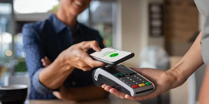 person paying with mobile wallet at checkout